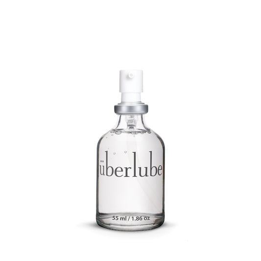 Clear spray bottle labeled 'uberlube' on a white background