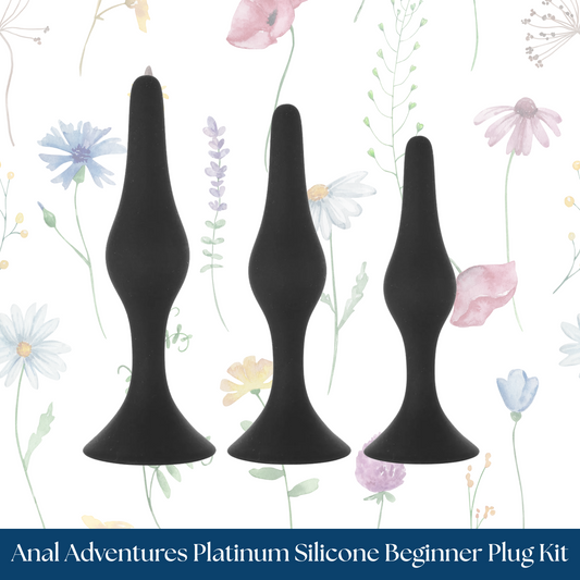 Three black silicone plugs on a floral background with 'Anal Adventures Platinum Silicone Beginner Plug Kit' text.
