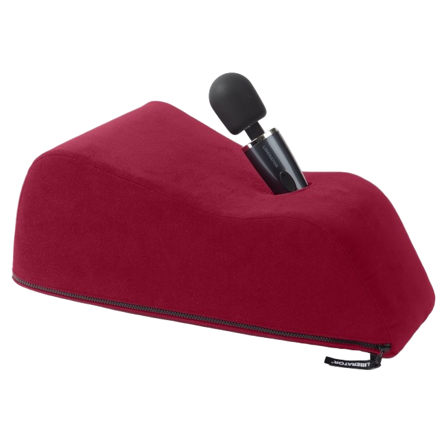 Wanda Toy and Mount by Liberator shown in merlot red microfiber. Angled pillow with wand-style vibrator inserted for hands-free use.