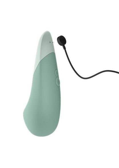 Mint green electronic device with a black cable on a white background